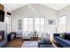 Bright living room with vaulted ceilings, fireplace, hardwood floors, and natural light at 16791 W 48Th Ln, Golden, CO 80403