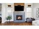 Living room fireplace with modern tile and wooden accents, plus windows with natural light at 16791 W 48Th Ln, Golden, CO 80403