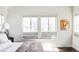 Bright bedroom featuring sunny windows, decorative pillows, and window treatments at 16791 W 48Th Ln, Golden, CO 80403