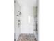 Modern shower featuring pebble flooring, mosaic tile accents, and a glass enclosure at 16791 W 48Th Ln, Golden, CO 80403