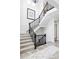 Elegant staircase with iron railings, carpeted steps, and tiled landing at 16791 W 48Th Ln, Golden, CO 80403
