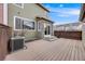 Spacious backyard with a composite deck, stone accents on the home and view of other homes at 22813 E Briarwood Pl, Aurora, CO 80016