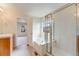 Bright bathroom featuring tile floors, soaking tub, and glass enclosed shower at 22813 E Briarwood Pl, Aurora, CO 80016