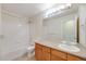 Bright bathroom featuring a shower-tub combination and a neutral-toned vanity with ample counter space at 22813 E Briarwood Pl, Aurora, CO 80016