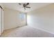 Comfortable carpeted bedroom with ceiling fan and natural light from a large window at 22813 E Briarwood Pl, Aurora, CO 80016