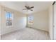 Bright carpeted bedroom with a ceiling fan and two windows that provide natural light at 22813 E Briarwood Pl, Aurora, CO 80016