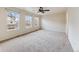 Bright bedroom with neutral carpet, ceiling fan, and multiple windows for natural light at 22813 E Briarwood Pl, Aurora, CO 80016
