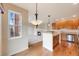 Open-concept kitchen showcases wooden cabinets, hardwood floors, and a view of the living area at 22813 E Briarwood Pl, Aurora, CO 80016