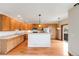 Well-lit kitchen with wood cabinets, stainless steel appliances, and a breakfast bar area at 22813 E Briarwood Pl, Aurora, CO 80016