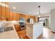Kitchen featuring stainless appliances, wood cabinets and hardwood floors, with an island at 22813 E Briarwood Pl, Aurora, CO 80016