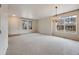 Spacious living room with plush carpet, chandelier, and natural light from large windows at 22813 E Briarwood Pl, Aurora, CO 80016