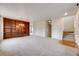 Open living room featuring a built-in bookshelf and staircase access to upper level at 22813 E Briarwood Pl, Aurora, CO 80016