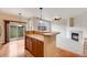 Open living area with breakfast bar, wood floors, fireplace, and sliding door to the outside at 22813 E Briarwood Pl, Aurora, CO 80016