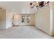 Large living room with neutral walls, carpet, and staircase access to upper level at 22813 E Briarwood Pl, Aurora, CO 80016