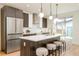 Modern kitchen with stainless steel appliances and a large island with seating at 4222 Stuart St, Denver, CO 80212