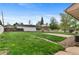 Spacious backyard featuring a well-maintained lawn and detached garage at 1549 Dean Dr, Northglenn, CO 80233