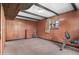 Finished basement area with retro wood paneling, small windows, and carpet at 1549 Dean Dr, Northglenn, CO 80233