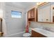Bright bathroom with vanity sink, medicine cabinet, and shower-tub combination at 1549 Dean Dr, Northglenn, CO 80233