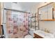 A bathroom with vanity sink, shower, and decorated shower curtain at 1549 Dean Dr, Northglenn, CO 80233