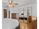 A bedroom with mirrored closet doors, ceiling fan and dresser at 1549 Dean Dr, Northglenn, CO 80233