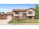 Charming two-story home with brick and siding exterior, a well-maintained front yard and attached garage at 1549 Dean Dr, Northglenn, CO 80233