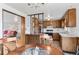 Cozy kitchen with wood cabinetry, white countertops, and a view of the living area at 1549 Dean Dr, Northglenn, CO 80233