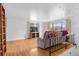 Bright living room with hardwood floors, large windows, and a comfortable recliner at 1549 Dean Dr, Northglenn, CO 80233