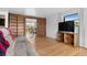 Open-concept living room with hardwood floors, a comfortable sofa, and a view of the dining area at 1549 Dean Dr, Northglenn, CO 80233