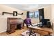 Comfortable home office featuring a desk, chair, window, and hardwood floors at 1549 Dean Dr, Northglenn, CO 80233