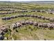 Expansive aerial view of a community of homes nestled in rolling green hills at 10757 Timberdash Ave, Highlands Ranch, CO 80126