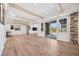 Spacious finished basement with light wood floors, exposed beams, and sliding glass doors to outside at 10757 Timberdash Ave, Highlands Ranch, CO 80126