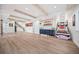 Spacious finished basement featuring light wood floors, exposed beams, and wet bar at 10757 Timberdash Ave, Highlands Ranch, CO 80126