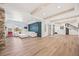 Finished basement with an oversized white couch, light wood floors, and exposed ceiling beams at 10757 Timberdash Ave, Highlands Ranch, CO 80126