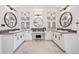 Symmetrical bathroom featuring white cabinets, marble floors, dual sinks and a makeup area at 10757 Timberdash Ave, Highlands Ranch, CO 80126