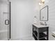 Bathroom with herringbone-patterned floor tiles, vanity, matte black fixtures, and glass enclosed shower at 10757 Timberdash Ave, Highlands Ranch, CO 80126