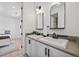Bathroom with dual sinks, dark hardware and modern mirrors at 10757 Timberdash Ave, Highlands Ranch, CO 80126