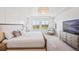 Bright bedroom featuring a TV, chair, large windows, and stylish furnishings at 10757 Timberdash Ave, Highlands Ranch, CO 80126