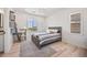 Bedroom featuring light wood floors, a desk, and a large window at 10757 Timberdash Ave, Highlands Ranch, CO 80126