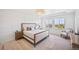 Bright bedroom with white walls, wood floors, large windows, and stylish furnishings at 10757 Timberdash Ave, Highlands Ranch, CO 80126