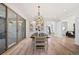 Elegant dining room with modern light fixture, sliding doors, and an open floor plan at 10757 Timberdash Ave, Highlands Ranch, CO 80126