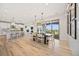 Open floor plan with dining area leading to the kitchen and outdoor balcony at 10757 Timberdash Ave, Highlands Ranch, CO 80126