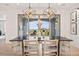 Elegant dining area featuring modern light fixtures and scenic outdoor views at 10757 Timberdash Ave, Highlands Ranch, CO 80126