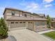 Elegant home with a three-car garage, stone accents, and well-maintained landscaping at 10757 Timberdash Ave, Highlands Ranch, CO 80126