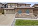 Charming home featuring stone accents, a three-car garage, and manicured lawn at 10757 Timberdash Ave, Highlands Ranch, CO 80126