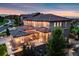 Aerial view of a two-story luxury home featuring a stone facade, tile roof, and lush landscaping at 10757 Timberdash Ave, Highlands Ranch, CO 80126
