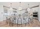 Spacious kitchen featuring a large island, modern appliances, and stylish lighting at 10757 Timberdash Ave, Highlands Ranch, CO 80126
