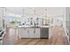 Open kitchen with granite countertops, modern appliances, large island, and light wood floors at 10757 Timberdash Ave, Highlands Ranch, CO 80126