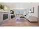 Bright and airy living room with a modern fireplace, large windows, and comfortable seating at 10757 Timberdash Ave, Highlands Ranch, CO 80126