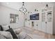 Bright living room with hardwood floors, custom built-ins, and a large window at 10757 Timberdash Ave, Highlands Ranch, CO 80126