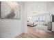 Bright and airy main bedroom with large windows, a sitting area, and a decorative light fixture at 10757 Timberdash Ave, Highlands Ranch, CO 80126